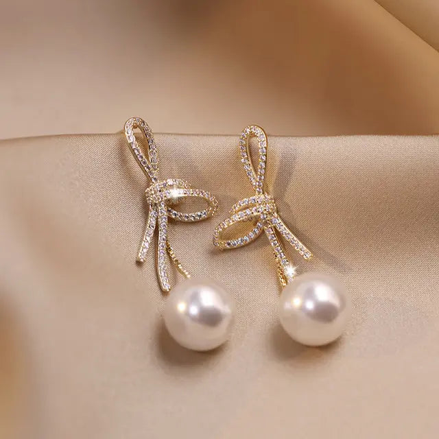 Pearl Earrings with a Shiny Gold Bow