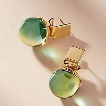 Vintage earrings with green crystals in gold